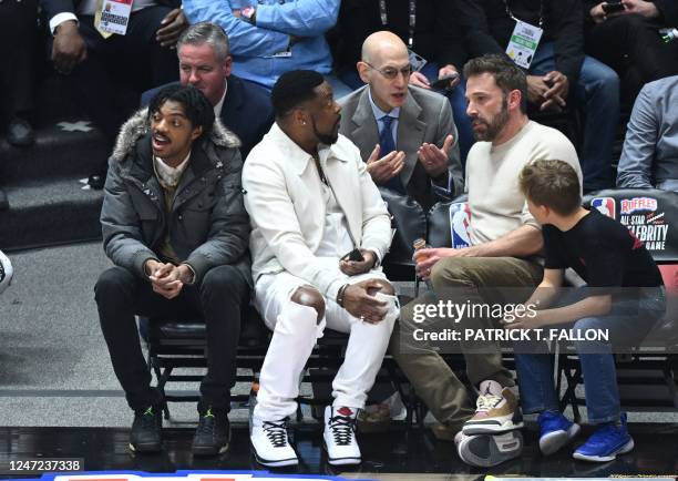 Commissioner Adam Silver speaks with actors Ben Affleck and his son Samuel Garner Affleck with Chris Tucker and his son Destin Christopher Tucker as...