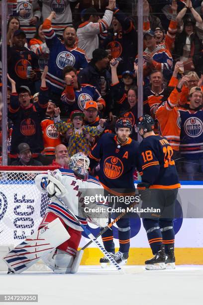 Leon Draisaitl and Zach Hyman of the Edmonton Oilers celebrate Draisaitl's goal against goaltender Igor Shesterkin of the New York Rangers during the...