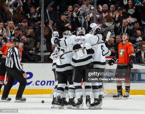 Anze Kopitar of the Los Angeles Kings celebrates his third-period goal with Kevin Fiala and Drew Doughty during the game against the Anaheim Ducks at...