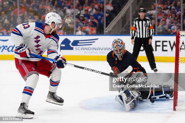 Alexis Lafreniere of the New York Rangers scores against goaltender Jack Campbell of the Edmonton Oilers during the shootout at Rogers Place on...