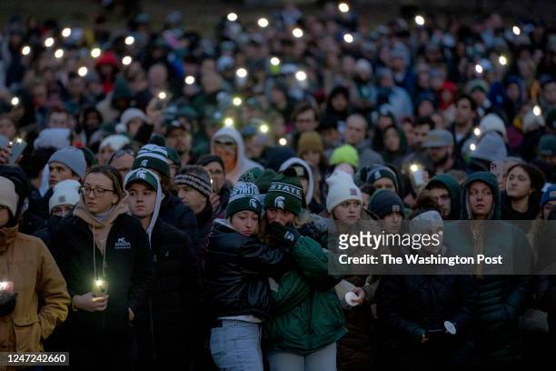 February 15: People gather during the vigil at The Rock on Michigan State Universitys campus in East Lansing, Michigan on February 15, 2023. On...