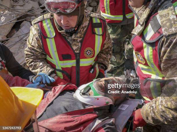 Two men and a child rescued by search and rescue teams from under the rubble of a collapsed building 296 hours after the powerful twin earthquakes...