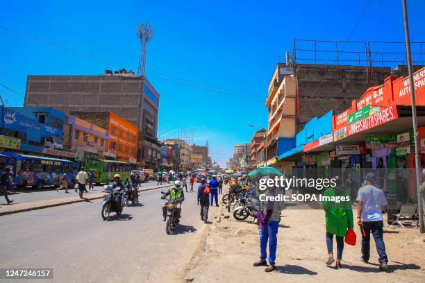 Pedestrians walk past the busy streets in Central Business District. Central Business District in Nairobi is the center of the city's commercial...