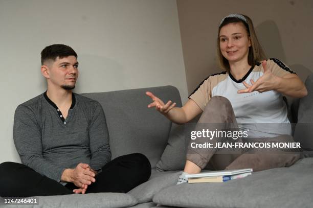 Ukrainian acrobats Tamila Perevarucha and Slave Iroshnikov sit in their apartment, in Montreuil-Juigne, western France, on February 2, 2023. - Eleven...