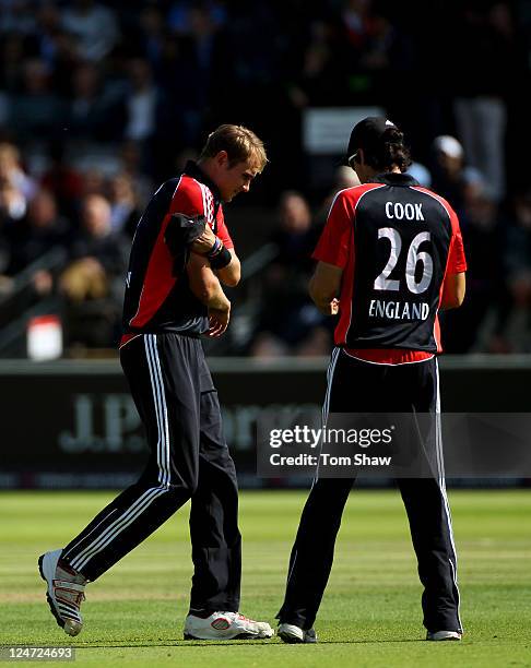 Stuart Broad of England holds his right arm as he walks past Alastair Cook on his way to the pavilion during the 4th Natwest One Day International...