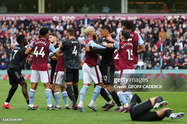 Arsenal's Norwegian midfielder Martin Odegaard lies injured as players clash during the English Premier League football match between Aston Villa and...