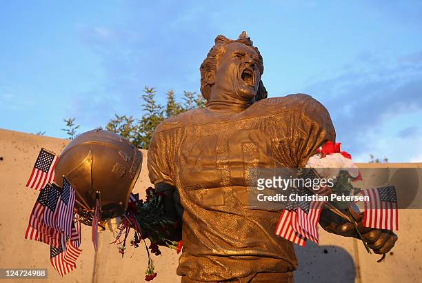 Fans adorn the Pat Tillman statue with American flags in honor of the 10 year anniversary of the 9/11 attacks following the NFL season opening game...