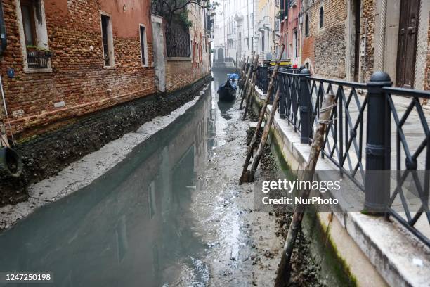 General view of a dry canal for low tide on February 16, 2023 in Venice, Italy