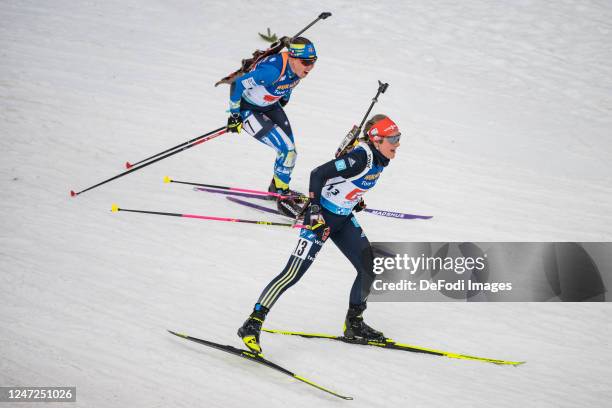 Anastasiya Merkushyna of Ukraine, Sophia Schneider of Germany in action competes during the Single Mixed Relay at the IBU World Championships...