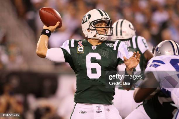 Mark Sanchez of the New York Jets throws a pass against the Dallas Cowboys in the first half during their NFL Season Opening Game at MetLife Stadium...