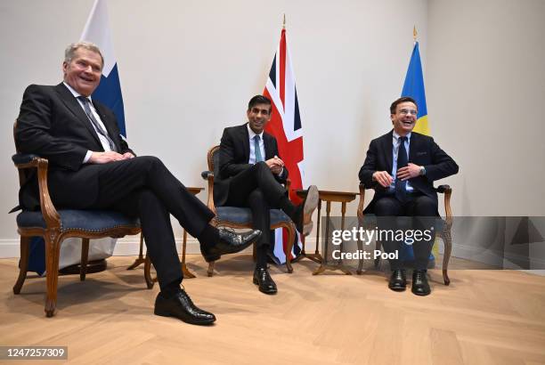 Finland's President Sauli Niinisto, Britain's Prime Minister Rishi Sunak and Sweden's Prime Minister Ulf Kristersson take a seat for their trilateral...