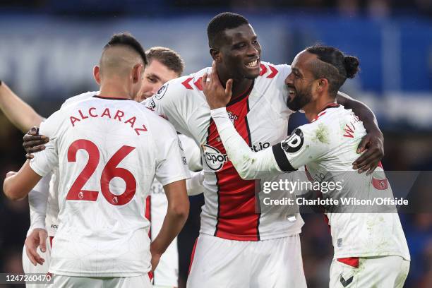 Jubilant Paul Onuachu of Southampton celebrates victory with Theo Walcott during the Premier League match between Chelsea FC and Southampton FC at...