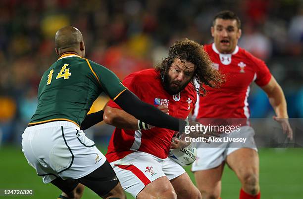 Wales Prop Adam Jones is tackled by Wing JP Pietersen of South Africa during the IRB 2011 Rugby World Cup Pool D match between South Africa and Wales...