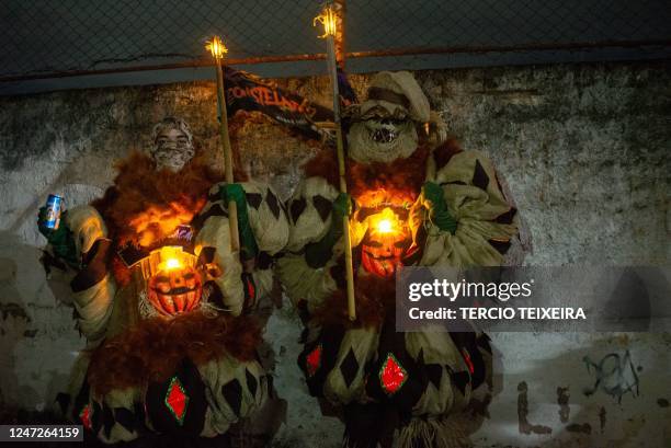 Members of the "Constelação" bate-bola street carnival band prepare to parade in Rio de Janeiro's suburb Vila Aliança, Brazil, on February 18, 2023....