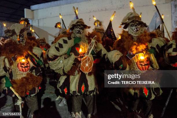 Members of the "Constelação" bate-bola street carnival band parade in Rio de Janeiro's suburb Vila Aliança, Brazil, on February 18, 2023. - The...