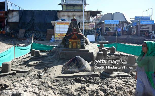 Sand artist Lakshmi Goud creates a sand sculpture of Kedarnath temple on the occasion of 'Maha Shivratri', at Juhu, on February 18, 2023 in Mumbai,...