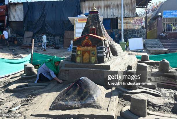 Sand artist Lakshmi Goud creates a sand sculpture of Kedarnath temple on the occasion of 'Maha Shivratri', at Juhu, on February 18, 2023 in Mumbai,...