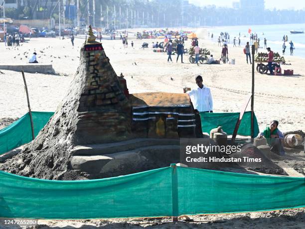 Sand artist Lakshmi Goud creates a sand sculpture of Kedarnath temple on the occasion of 'Maha Shivratri', at Juhu, on February 18, 2023 in Mumbai,...