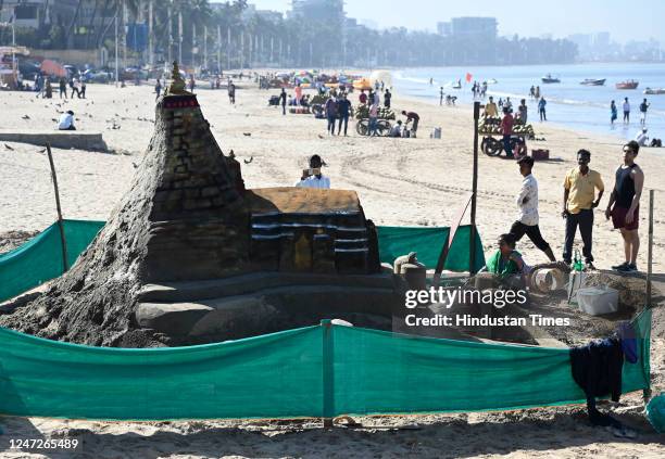 Sand artist Lakshmi Goud creates a sand sculpture of Kedarnath temple on the occasion of 'Maha Shivratri', at Juhu, on February 18, 2023 in Mumbai,...