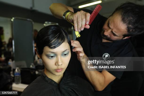 Model gets ready in the backstage prior to the Richard Quinn's Autumn/Winter 2023 fashion show collection on the second day of the London Fashion...