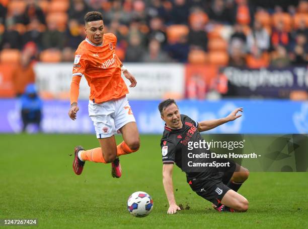 Blackpool's Morgan Rogers is tackled by Stoke City's Phil Jagielka during the Sky Bet Championship between Blackpool and Stoke City at Bloomfield...