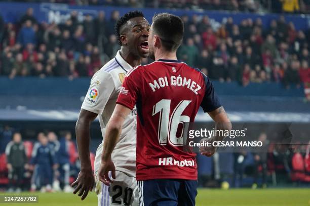 Osasuna's Spanish forward Moi Gomez argues with Real Madrid's Brazilian forward Vinicius Junior during the Spanish League football match between CA...