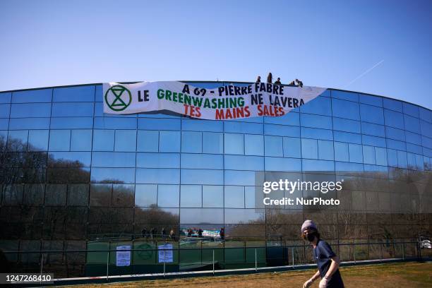 Activists put a giant banner on the roof of the Fabre's headquarters reading 'A69 - Pierre Fabre, the greenwashing won't clean your dirty hands'. The...