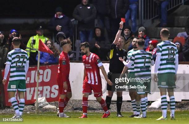 Sligo , Ireland - 18 February 2023; Referee Damien MacGraith shows a red card to Roberto Lopes of Shamrock Rovers during the SSE Airtricity Men's...