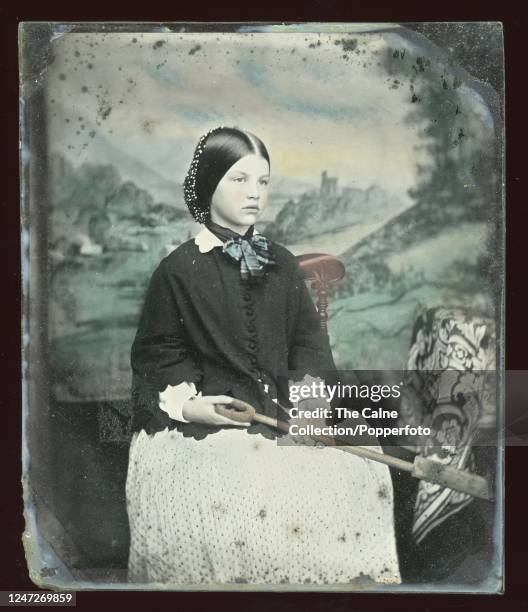 Vintage 19th Century tinted 6th Plate ambrotype, with painted backdrop, the subject identified as Alice Mary Beech , she wears a voluminous white...