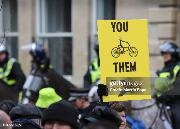 Protester holds a sign criticising the inequality of 15-minute cities as protesters gather in Broad Street on February 18, 2023 in Oxford, England....