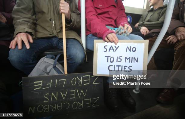 Protesters use the park and ride bus scheme to head into the city centre to protest about 15 Minute Cities with their protest signs on February 18,...