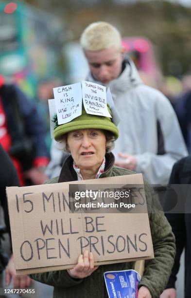 Protester holds a sign saying 15 Minute Cities Will Be Open Prisons as protesters gather in Broad Street to demonstrate against 15-minute cities on...