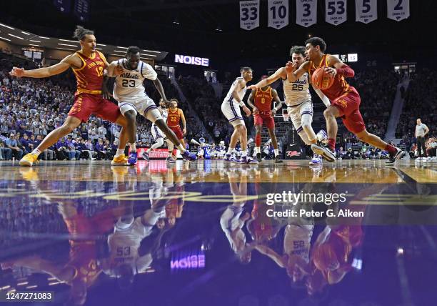 Tamin Lipsey of the Iowa State Cyclones drives to the basket with the ball against Ismael Massoud of the Kansas State Wildcats in the first half of...
