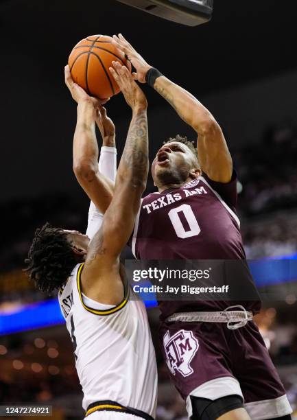 Dexter Dennis of the Texas A&M Aggies shoots against DeAndre Gholston of the Missouri Tigers during the first half at Mizzou Arena on February 18,...