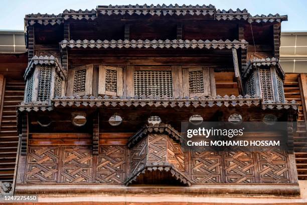 This picture shows a view of a mashrabiya, a balcony enclosed with carved wood latticework in traditional Islamic architecture, at the historical...