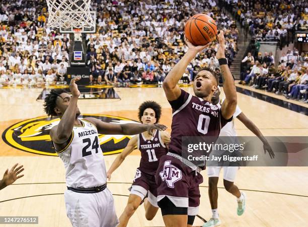 Dexter Dennis of the Texas A&M Aggies shoots against Kobe Brown of the Missouri Tigers during the second half at Mizzou Arena on February 18, 2023 in...