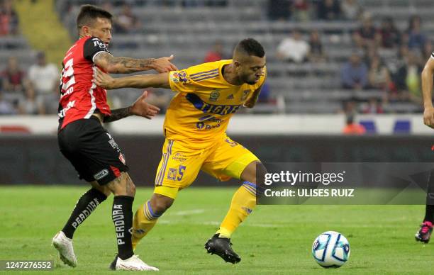 Brian Lozano of Atlas vies for the ball with Rafael De Souza of Tigres during their Mexican Clausura tournament football match at the Jalisco stadium...