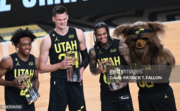 Utah Jazz's players Collin Sexton , Walker Kessler , Jordan Clarkson and the team mascot Jazz Bear pose with the winner trophy of the Kia skills...
