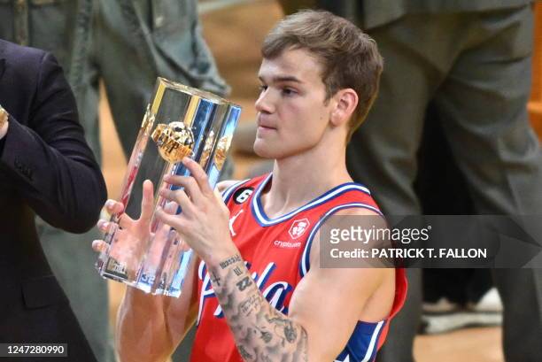 Basketball player Mac McClung, of the Philadelphia 76ers, holds the trophy after winning the Slam Dunk Contest of the NBA All-Star week-end in Salt...