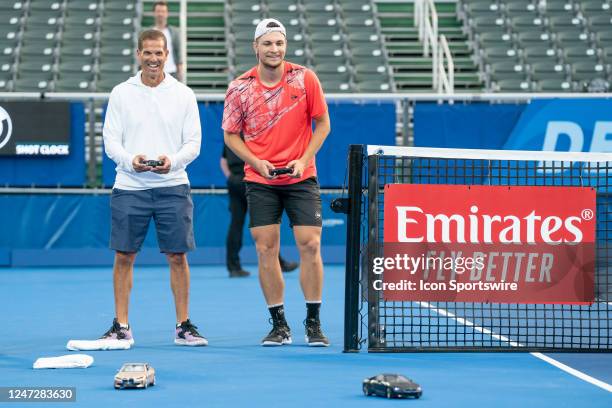 Miomir Kecmanovic races remote control cars after winning the Semifinals round of the ATP Delray Beach Open on February 18 at the Delray Beach...