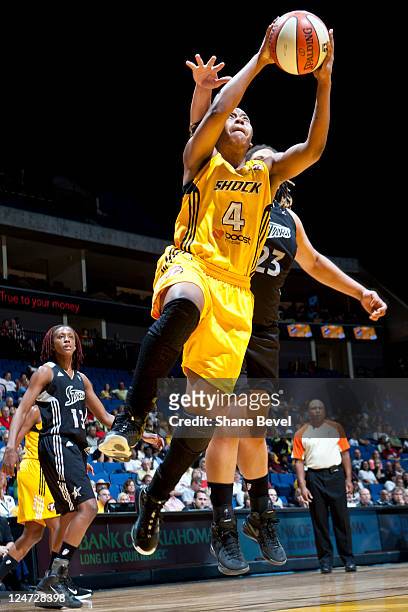 Danielle Adams of the San Antonio Silver Stars tries to stop a shot by Amber Holt of the Tulsa Shock during the WNBA game on September 11, 2011 at...