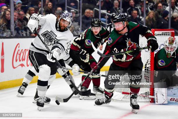 Alex Iafallo of the Los Angeles Kings and Nick Ritchie of the Arizona Coyotes battle for position during the third period at Crypto.com Arena on...