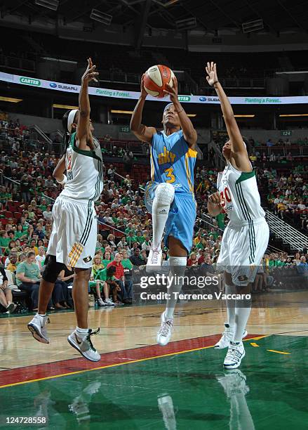 Dominique Canty of the Chicago Sky goes to the basket against Swin Cash and Tanisha Wright of the Seattle Storm during the game on September 11, 2011...