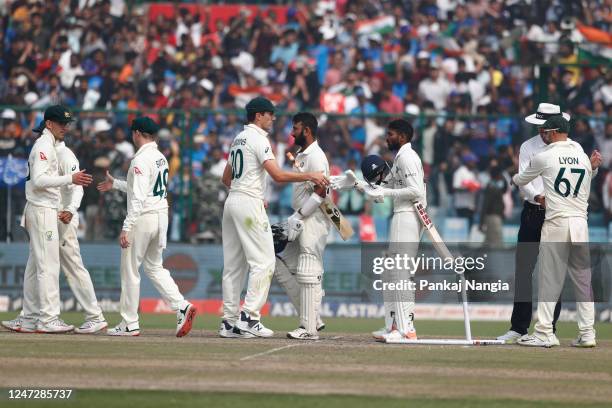 Bharat and Cheteshwar Pujara of India shake hands with Australian players after the victory during day three of the Second Test match in the series...