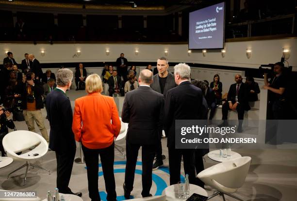 Former boxer Vladimir Klitschko stands together with other panel participants as he attends a townhall meeting at the Munich Security Conference in...