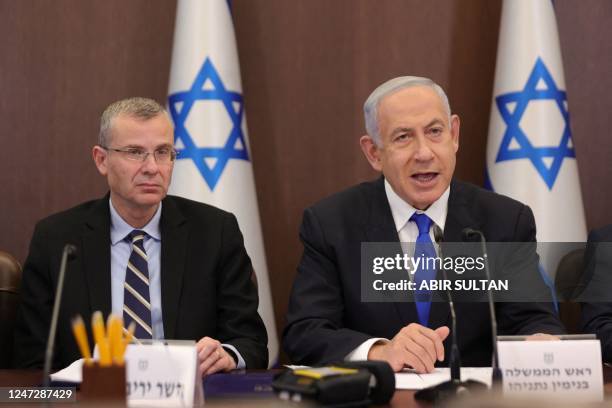 Israeli Prime Minister Benjamin Netanyahu and Justice Minister Yariv Levin attend the weekly cabinet meeting in the prime minister's office in...