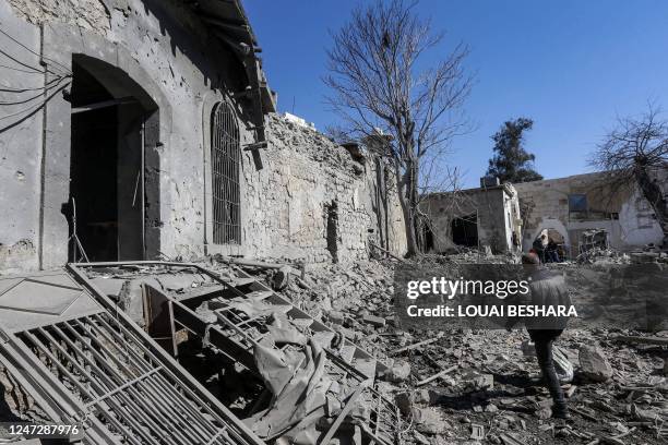 Man inspects damage in the aftermath of an Israeli air strike that hit the medieval Citadel of Damascus on February 19, 2023. - The air strike on...