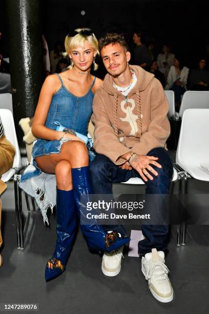 Mia Regan and Romeo Beckham attend the JW Anderson front row during London Fashion Week February 2023 at The Roundhouse on February 19, 2023 in...
