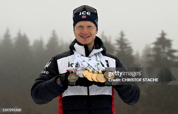 Norway's Johannes Thingnes Boe poses with all the medals he won during the IBU Biathlon World Championships in Oberhof, eastern Germany, after the...