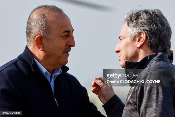 Secretary of State Antony Blinken talks to Turkish Foreign Minister Mevlut Cavusoglu as he arrives at Incirlik Air Base near Adana on February 19 for...